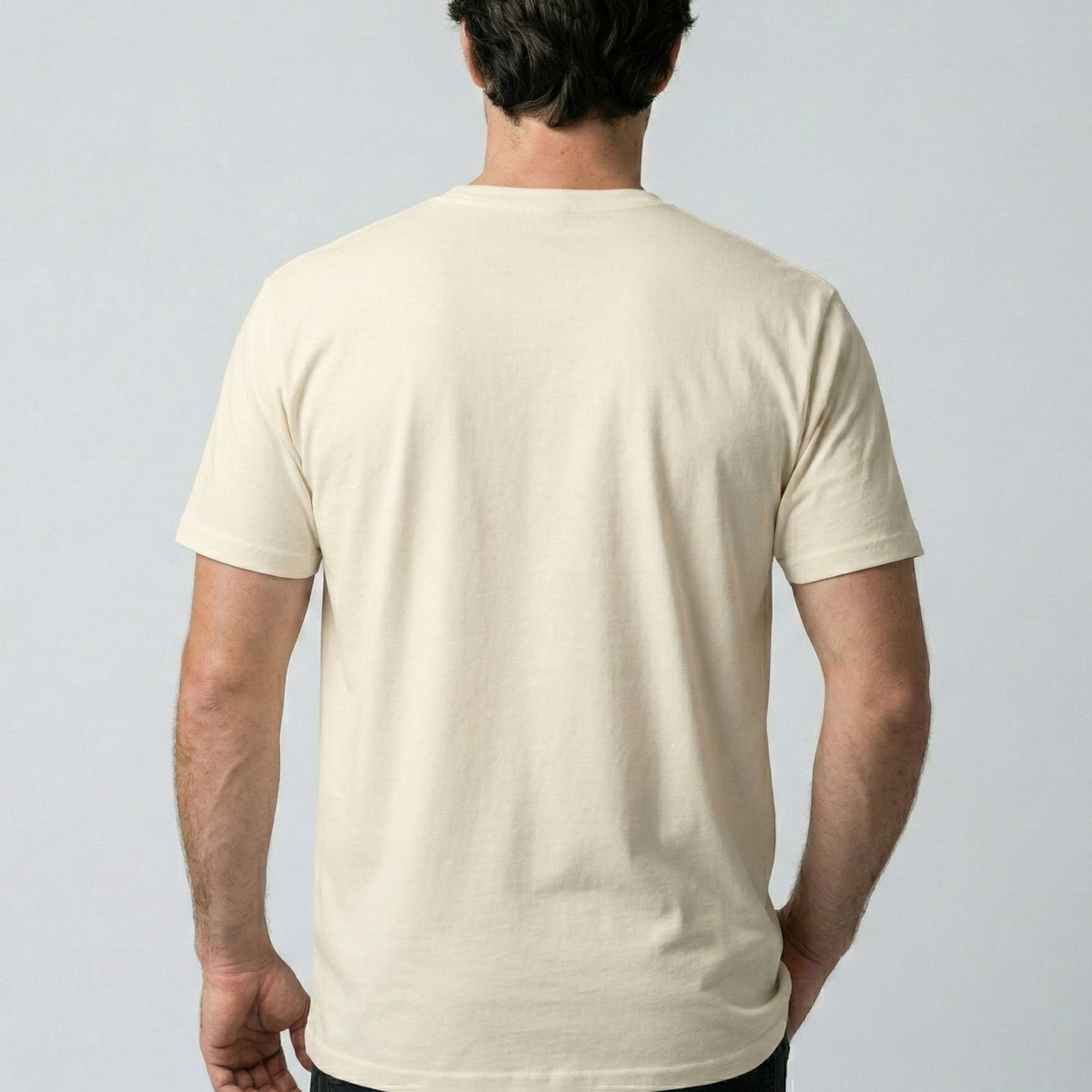 Person wearing a plain beige t-shirt against a light gray background
